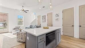 A modern kitchen with a central island, grey cabinetry, and pendant lighting. - - Chic New Home - Walk to River Ranch - King Bed - 2 Master Suites- A+ Location. (Lafayette)