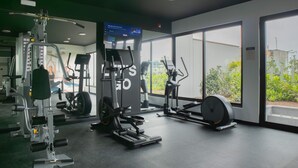 A gym with various exercise equipment, large windows, and a mirror. - w Comfortable 2BR Stay in Miraflores (Lima)