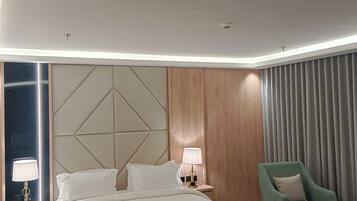 Junior Suite, City View | Premium bedding, in-room safe, laptop workspace, blackout drapes