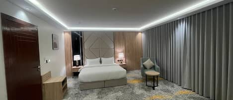 Junior Suite, City View | Premium bedding, in-room safe, laptop workspace, blackout drapes