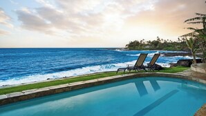 A pool with two lounge chairs facing the ocean. - Kukuiula Bay House By Parrish - Oceanfront Family Home (Koloa)