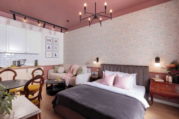 A bedroom with a bed, bedside table, and a nightstand with a vase.