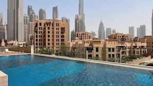 A swimming pool with a view of high-rise buildings in the background. - Vogue | Downtown near Dubai Mall | Burj Khalifa (Dubai)