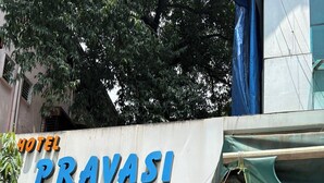 A sign for "Pravasi Residency" with a white car parked in front. - Pravasi Residency (Mumbai)