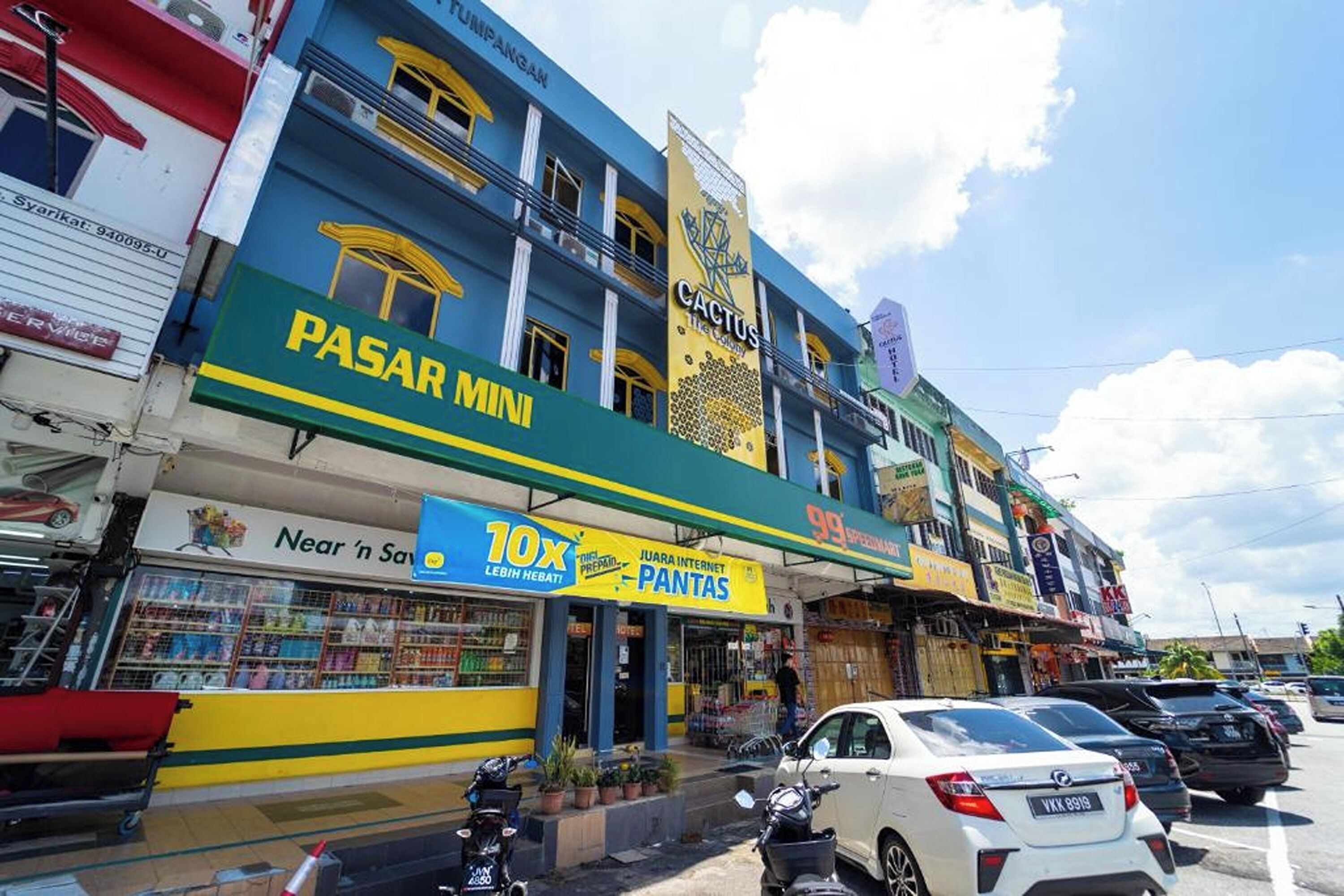 A multi-story building with a prominent 'PASAR MINI' sign, indicating a market or shopping area.
