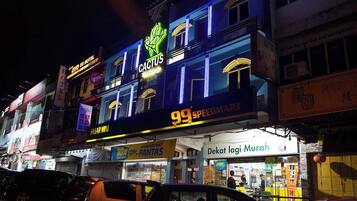 A building with multiple signs including 'Cactus', '99 SpeedMart', and 'Dekat Laji Murah'.