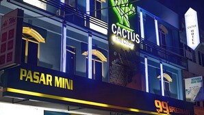 A building with multiple signs, including "Cactus Hotel," "PASAR MINI," and "99 SpeedMani." - The Colony By Cactus Hotel Johor Jaya (Johor Bahru)