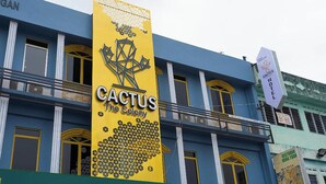A building with a prominent yellow sign for 'Cactus The Colony' and a sign for 'Cactus Hotel'. - The Colony By Cactus Hotel Johor Jaya (Johor Bahru)