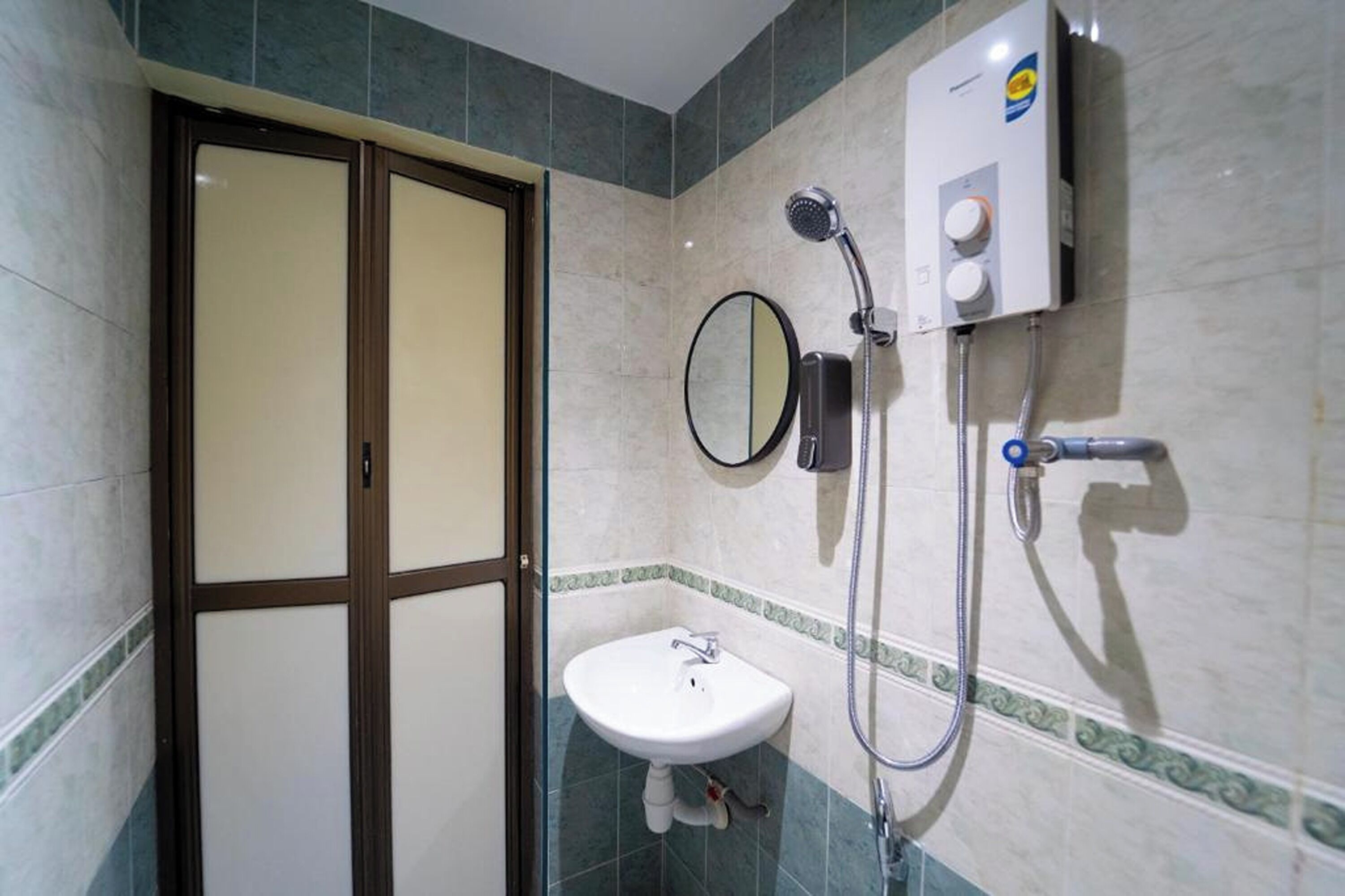 Une salle de bain équipée de toilettes, d’un lavabo et d’une douche.