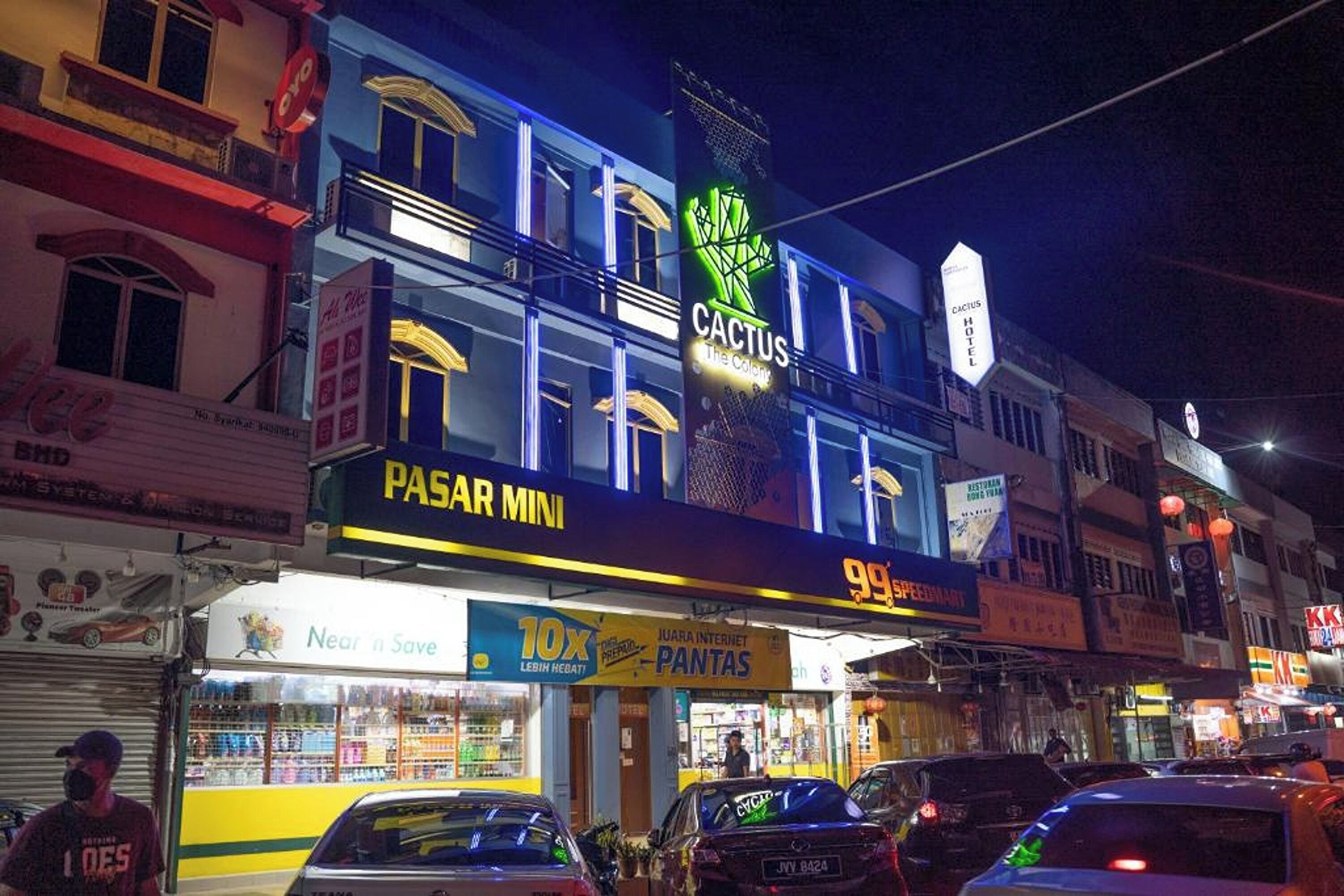 A multi-story building with a prominent 'Cactus Hotel' sign.