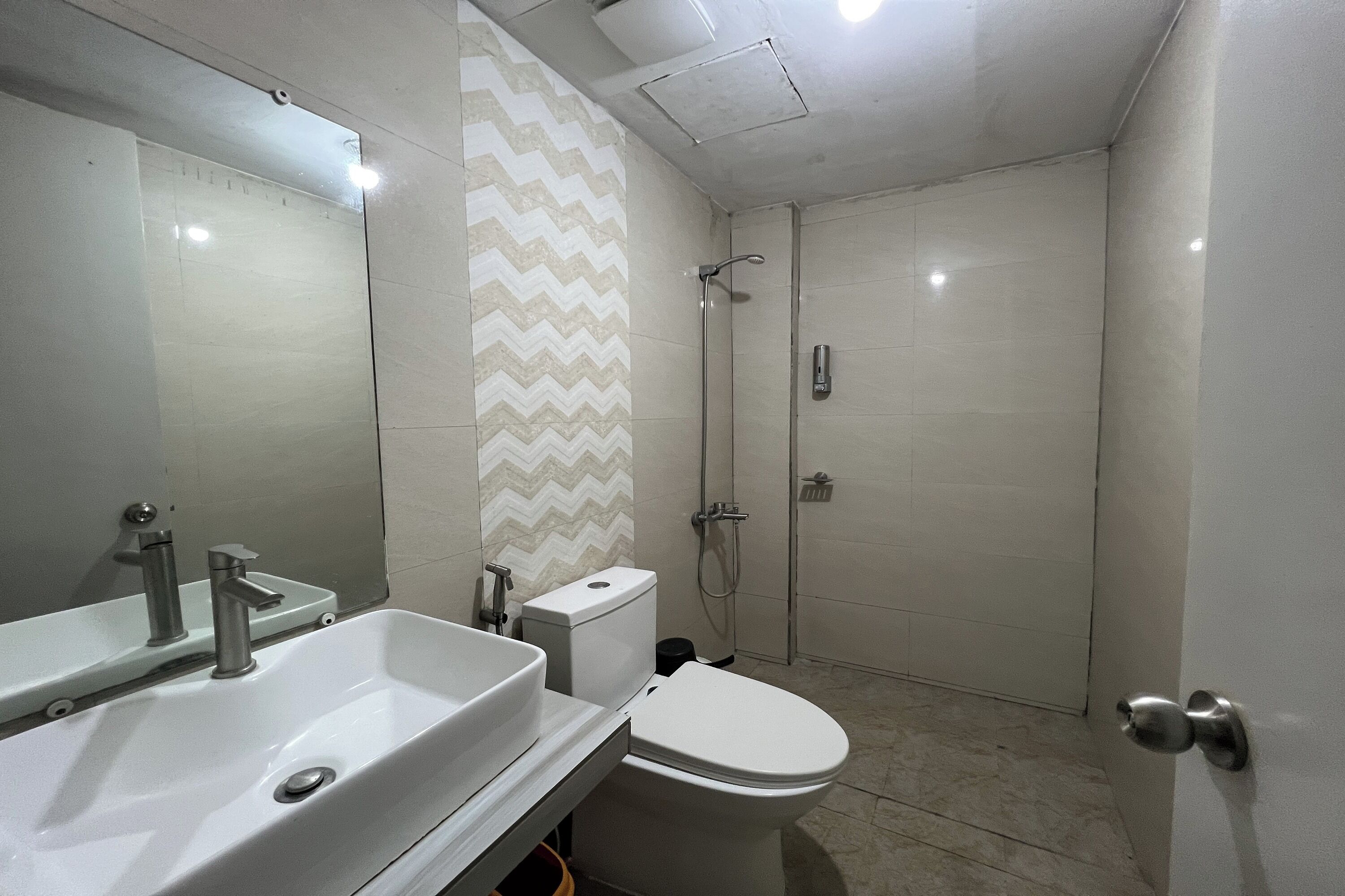 A bathroom with a sink, toilet, and shower.