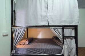 A bunk bed with a headboard, curtains, and a mattress with pillows. - Hostel Happy Elephant (Chiang Mai)