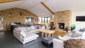 A spacious living area with a pool table, sofas, and a fireplace. - Highgate House (Dronfield)