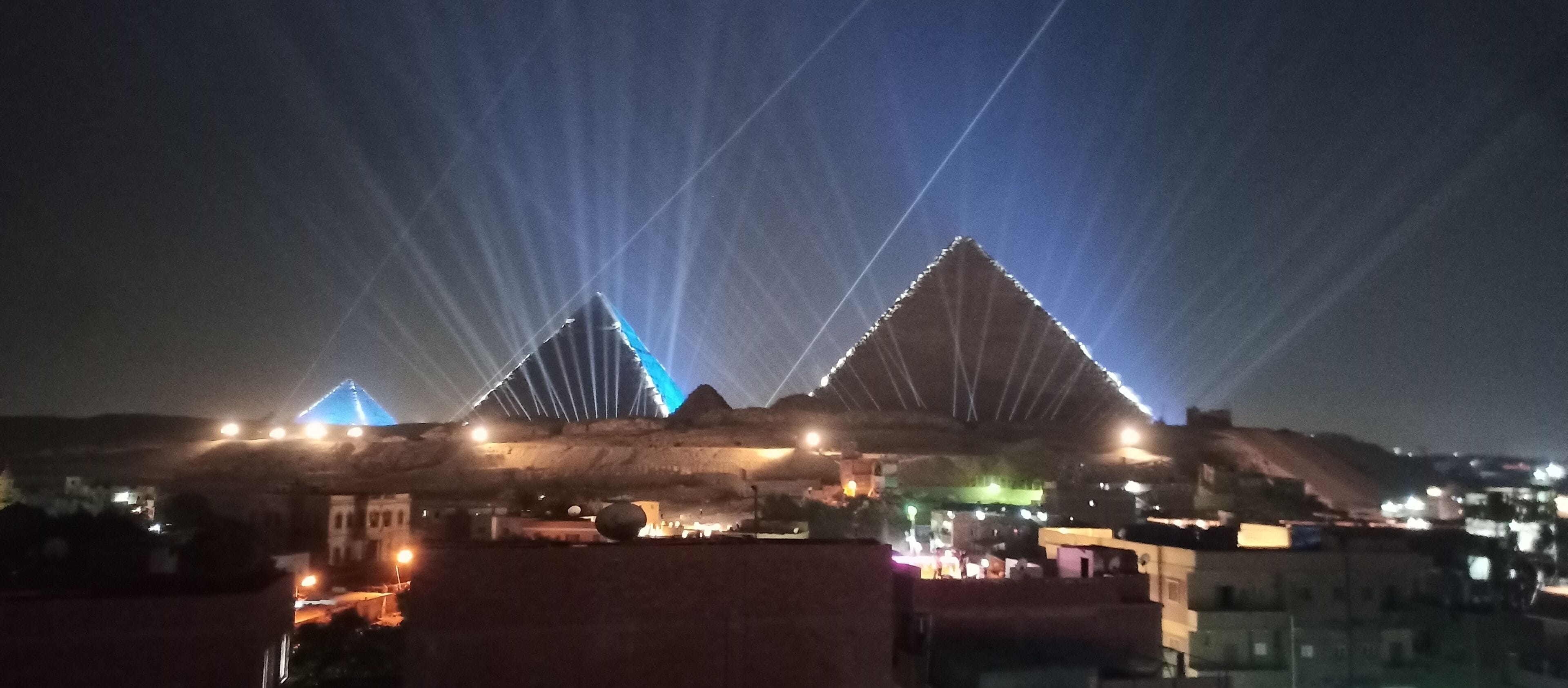 A large, illuminated structure with triangular shapes and a series of lights.
