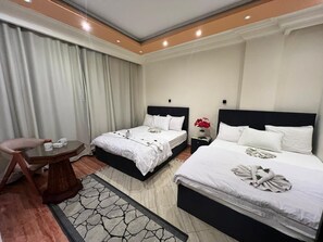 Deluxe Quadruple Room, Garden View | In-room safe, blackout drapes, soundproofing, iron/ironing board