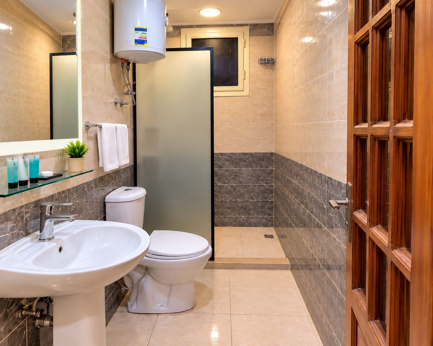 A bathroom with a sink, toilet, and a shower area.