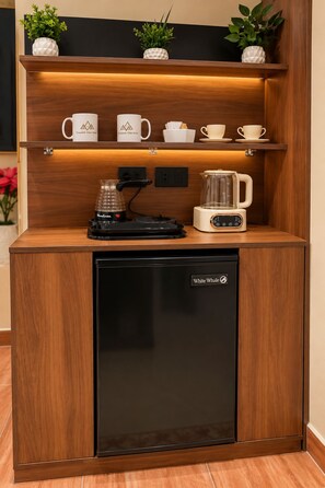 A compact kitchenette with a coffee maker, a kettle, and a refrigerator labeled 'White Whale.' - Queens Isis Pyramids View (Giza)