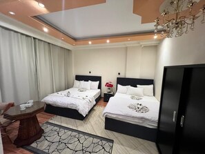 Deluxe Quadruple Room, Garden View | In-room safe, blackout drapes, soundproofing, iron/ironing board