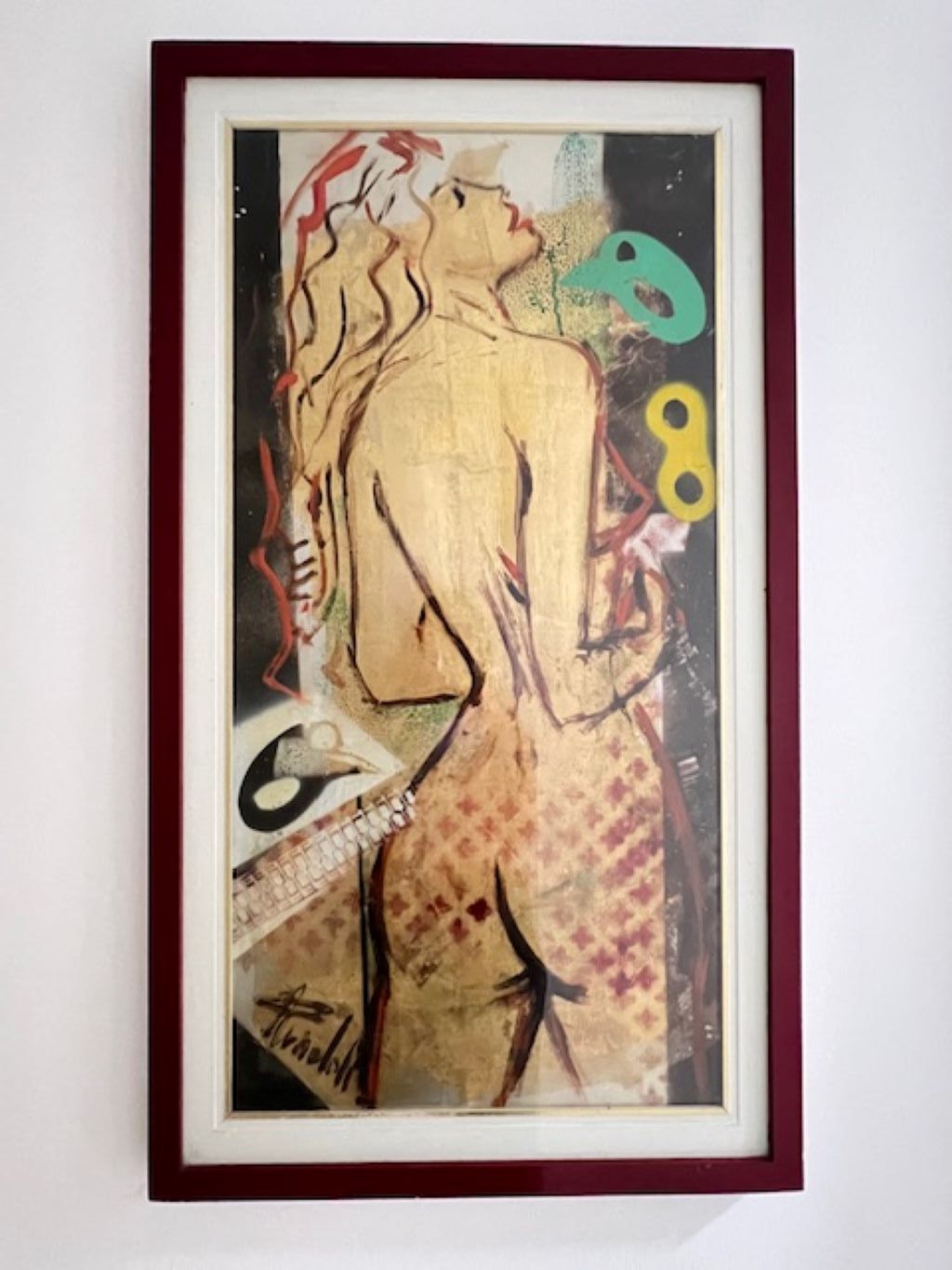 A framed artwork with abstract human figures and geometric shapes.