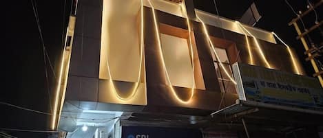 A building with a prominent 'NIRVIS GRAND' sign.