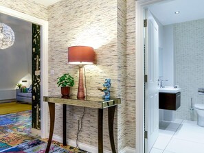 A modern bathroom with a white sink, a toilet, and a shower area.
