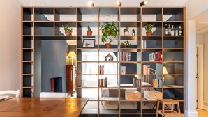 Une pièce avec une bibliothèque en bois, une table à manger et une cheminée.