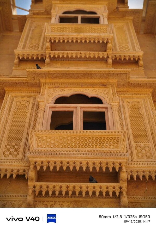 A detailed architectural model of a building with ornate carvings and multiple balconies.