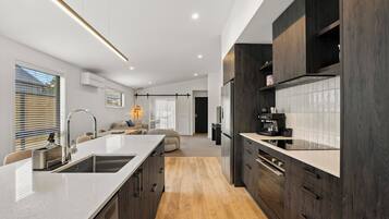 Fridge, microwave, coffee/tea maker, cookware/dishes/utensils