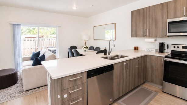 A modern kitchen with a dishwasher, a coffee bar, and a large oven. - Stylish Stay Near Hard Rock Stadium (North Miami Beach)