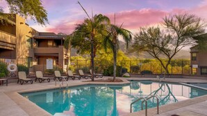A pool area with lounge chairs and a clear view of the surrounding buildings. - East / Sabino / 2 BR 2BA / Golf View / Htd Pools (Tucson)
