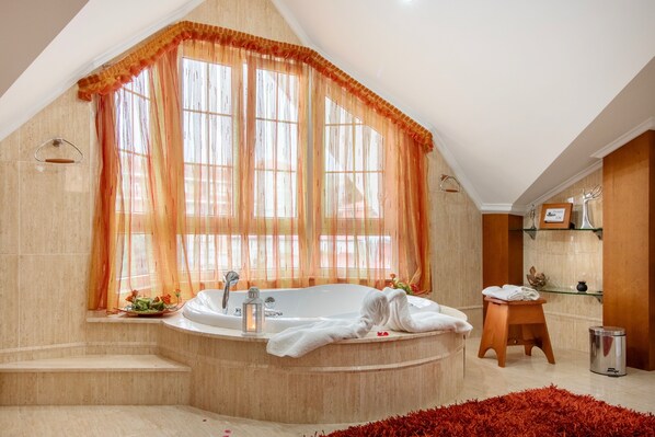 A modern bathroom with a freestanding bathtub, a vanity with a mirror, and a shower area.