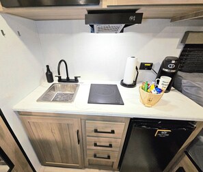 Fridge, microwave, coffee/tea maker, cookware/dishes/utensils