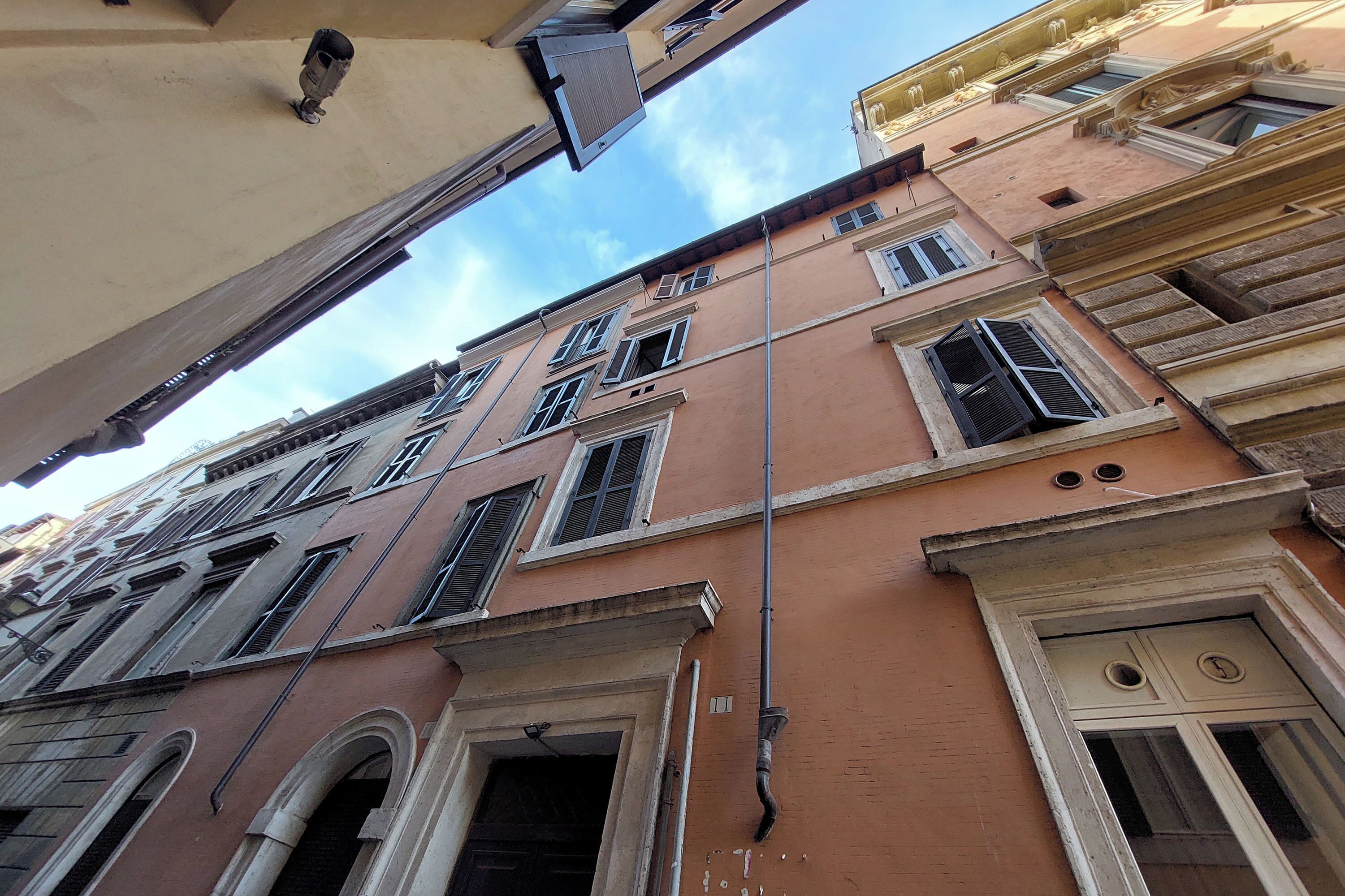 A multi-story building with arched windows and a central entrance.