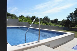 A rectangular swimming pool with a metal ladder, surrounded by a concrete wall and a tiled deck. - Luxury Villa Tara, 4 bedroom Villa with heated big pool (Medulin)