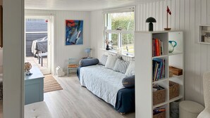 A cozy bedroom with a bed, a bookshelf, and a window. - Nice home in Slagelse with WiFi (Slagelse)