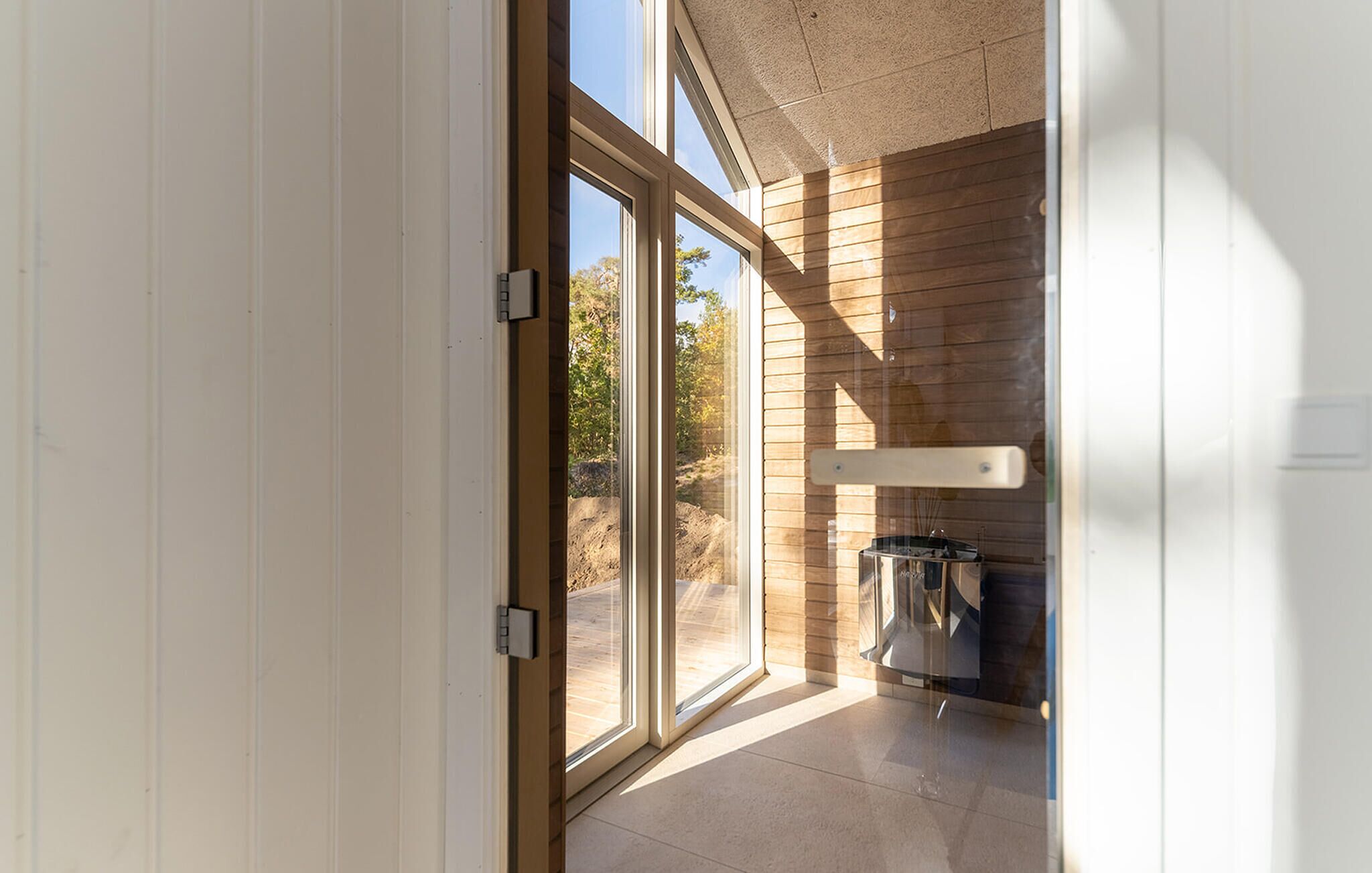 A modern interior with large sliding glass doors leading to an outdoor area.