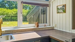 A kitchen with a large window, a sink, and a wooden countertop. - Stunning home in Oksbøl with sauna (Oksbøl)