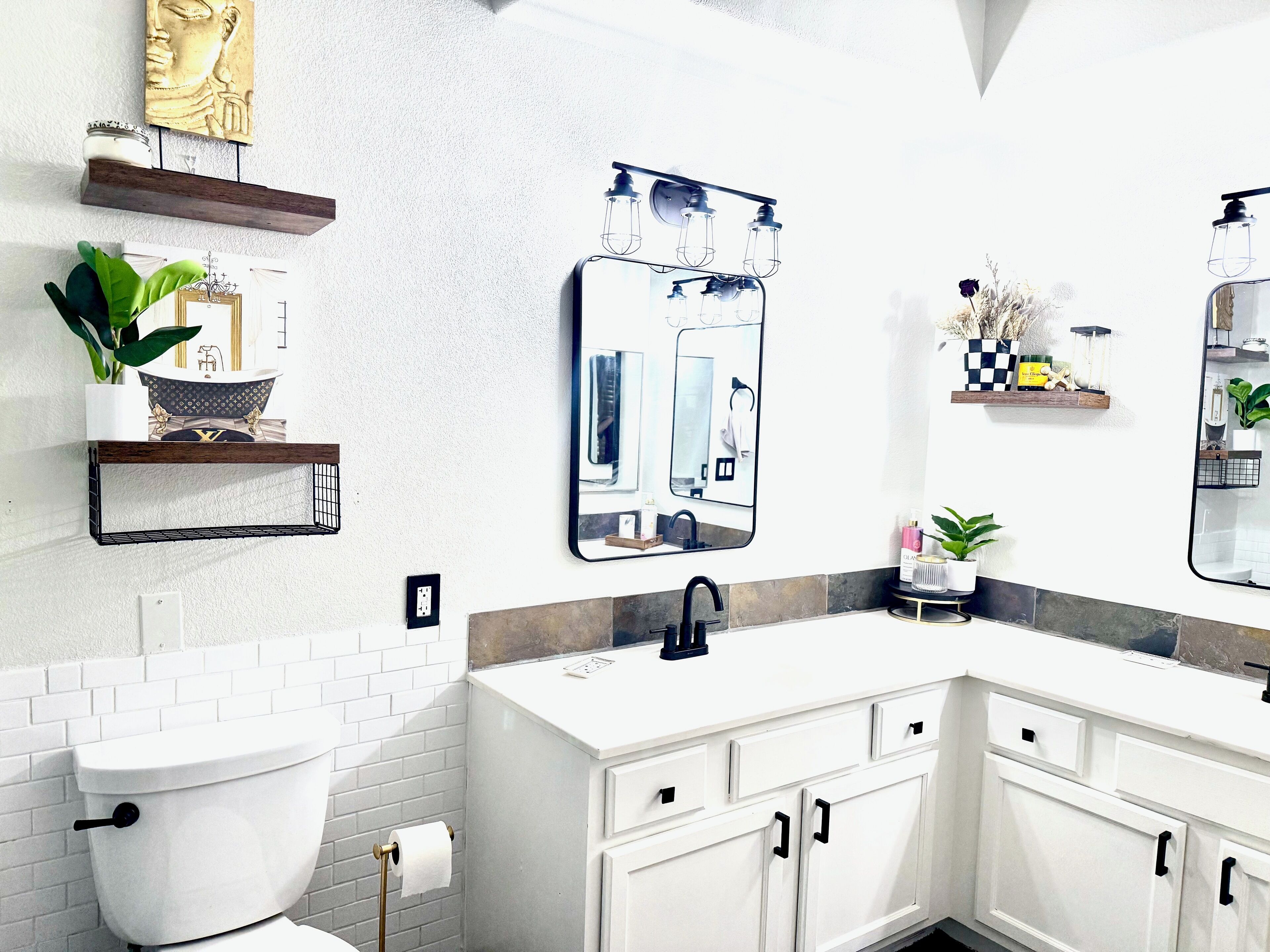 A modern bathroom with a white toilet, a double sink vanity, and a large mirror.