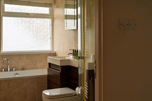 A bathroom with a bathtub, sink, and toilet. - White Sands  - sleeps 10 guests  in 5 bedrooms (Croyde)