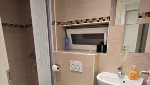 A modern bathroom with a toilet, bidet, and sink. - Modern & cozy apartment opposite the Deister (Barsinghausen)