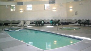 An indoor swimming pool with multiple lanes, surrounded by chairs and tables. - Peaks & Peace - Spacious Condo in Silverthorne with jacuzzi and fitness room (Silverthorne)