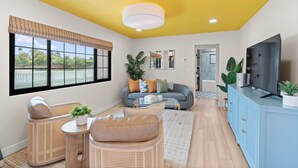 A living room with a sofa, chairs, a TV, and a large window with blinds. - New Modern Luxury, 3/2 Fam Friendly, BBQ, Central! (Encinitas)
