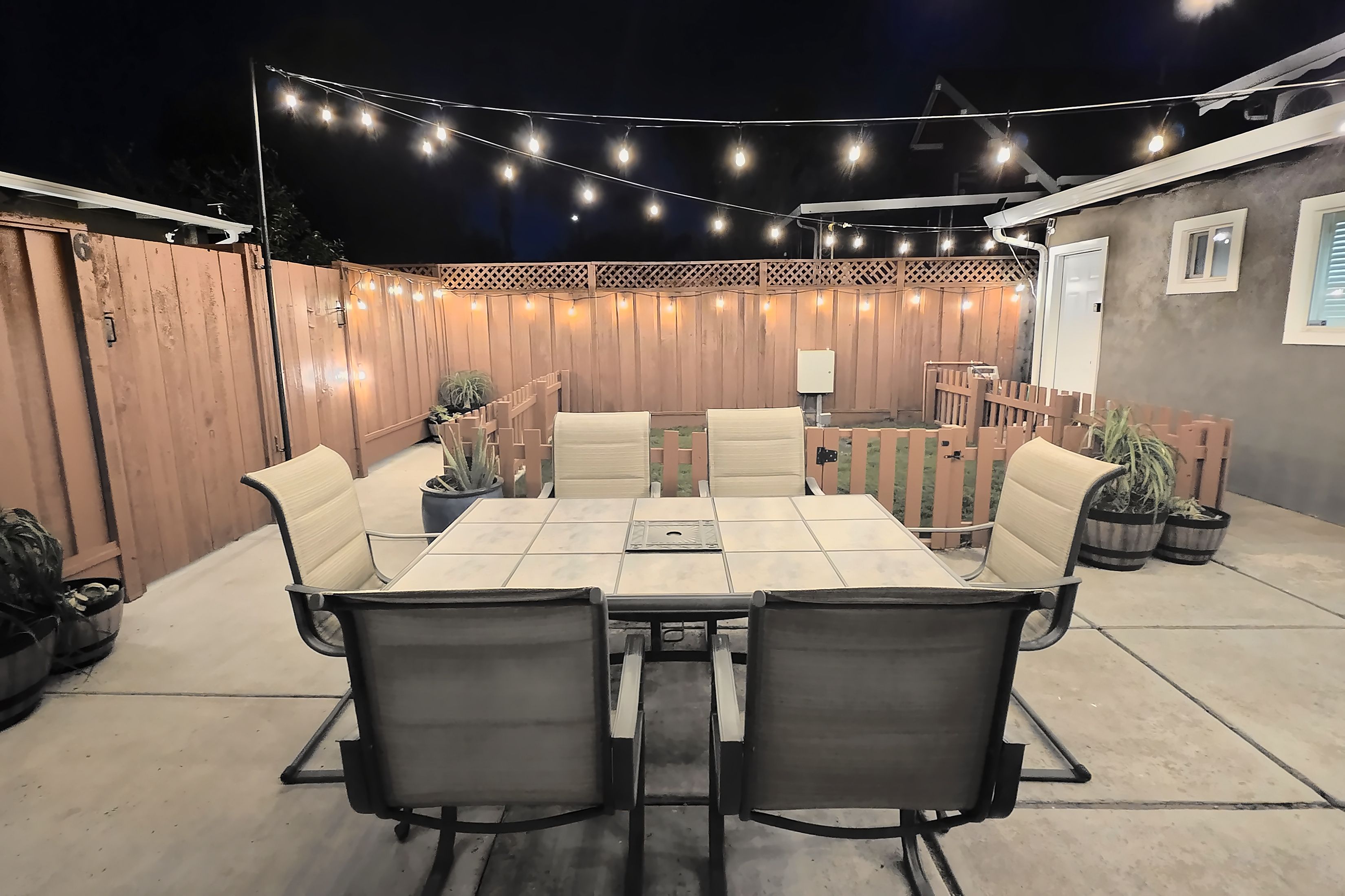 Shared backyard with string lights, shared with guests of the back units