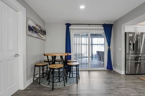 A kitchen with a dining area, a refrigerator, and a view to the outside. - Luxe by Jenn • 3BR Retreat w/ Heated Pool (Lauderdale Lakes)