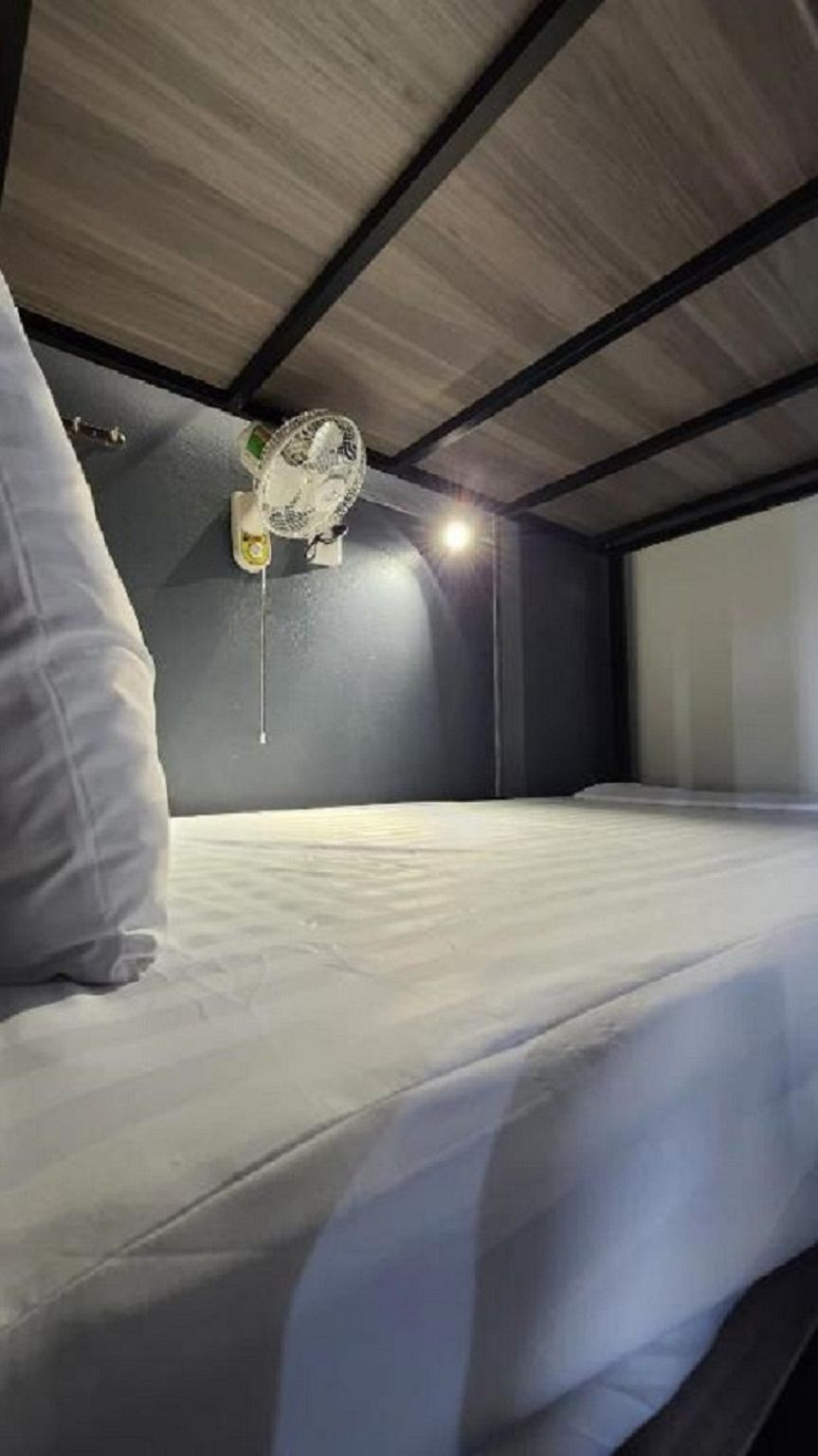A bunk bed with a hanging light fixture above it.