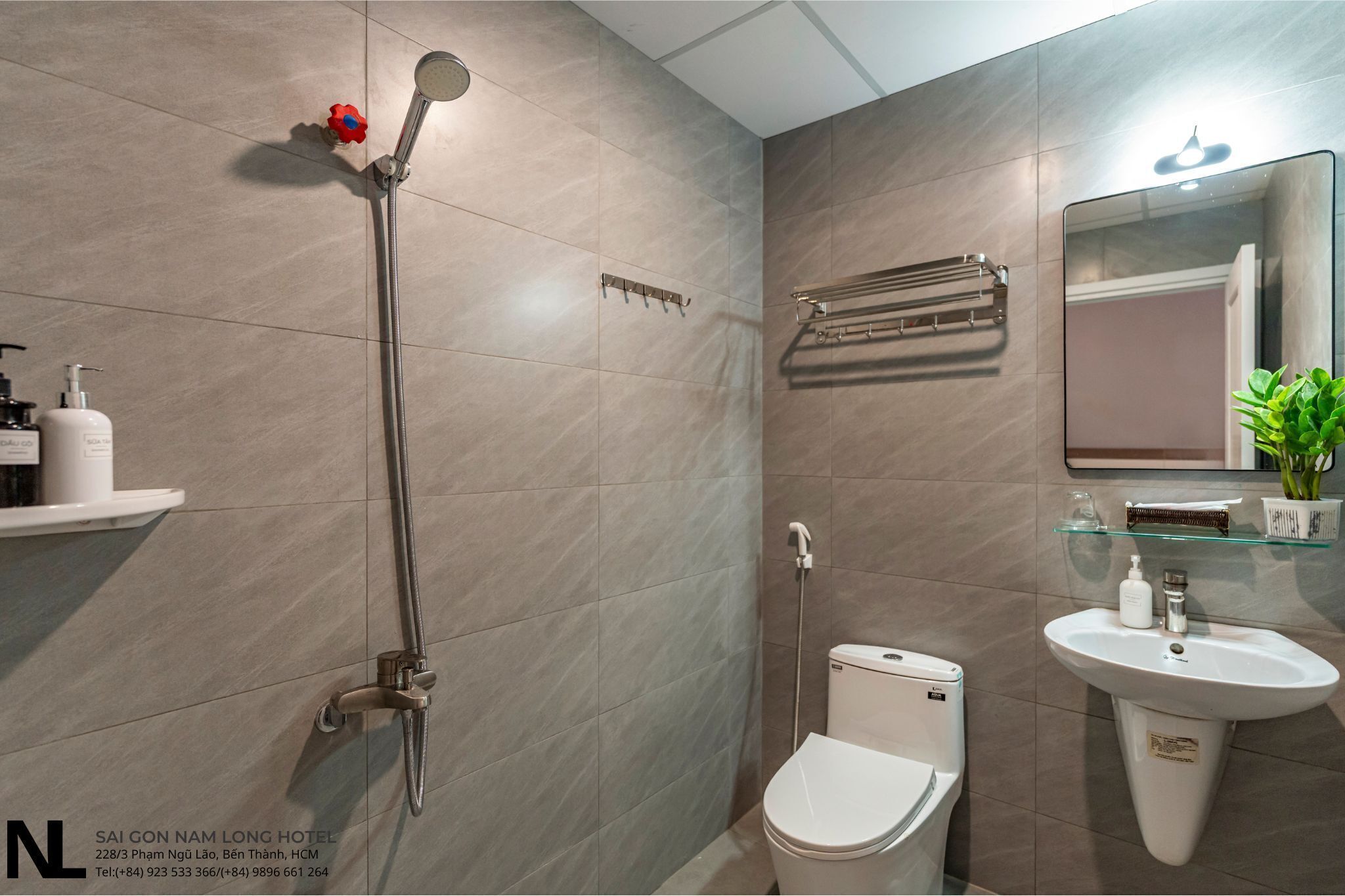 Une salle de bain moderne équipée d’une douche, de toilettes et d’un lavabo.