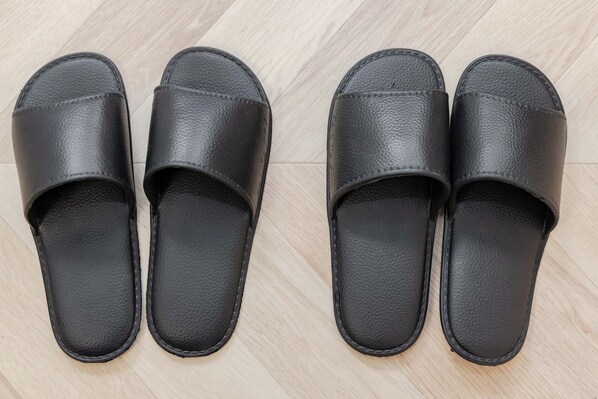 Four black leather slippers on a wooden floor. - Aimer (Tokyo)