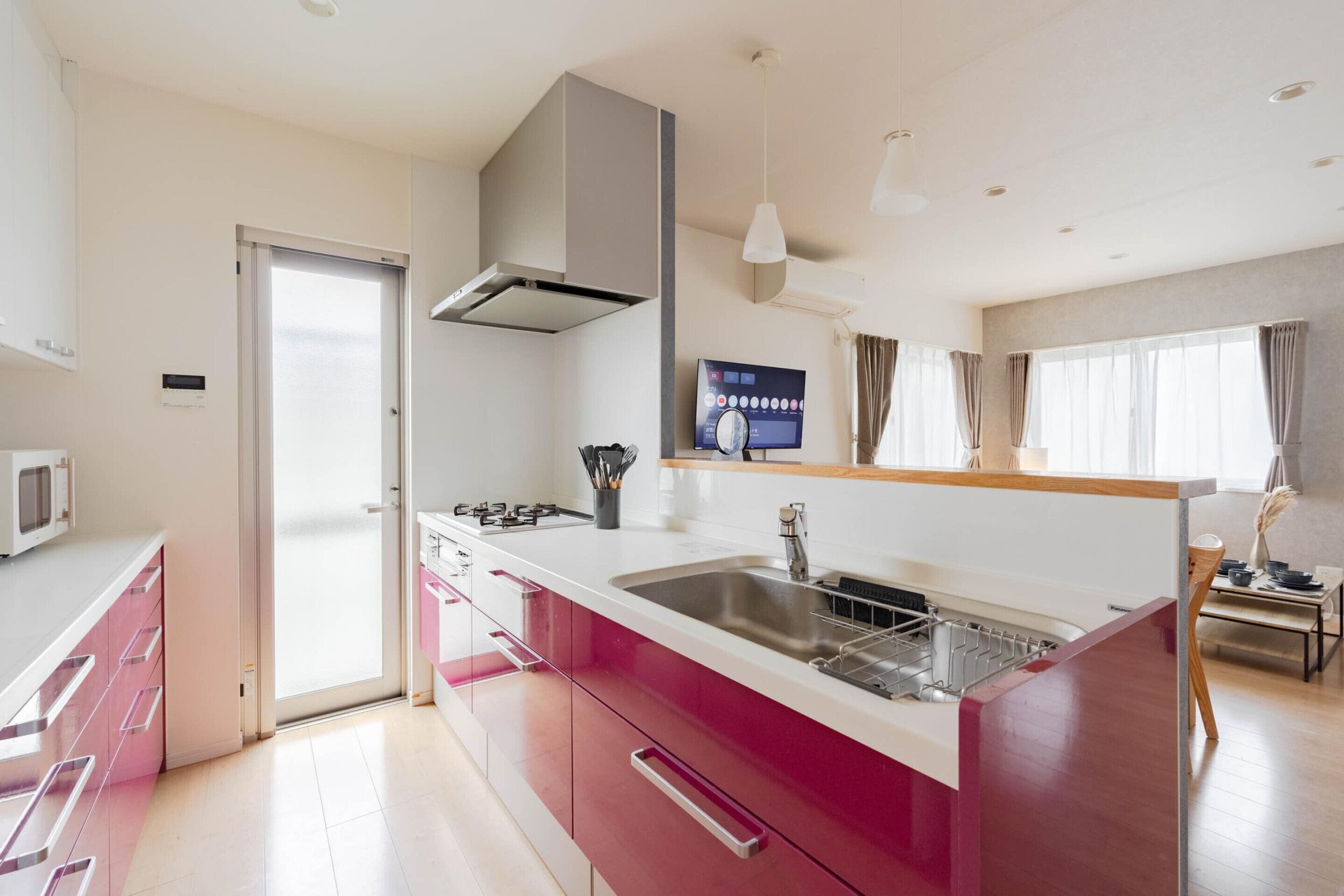 A modern kitchen with a central island, a microwave, and a stove.
