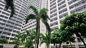 A high-rise residential building with multiple balconies and a central core. - Charm's City Escape at Grace Residences (Taguig)