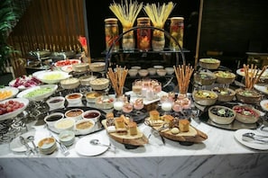 A buffet with various food items and utensils. - The House Bomonti (İstanbul)